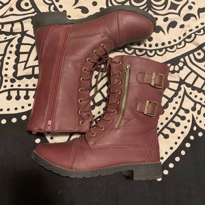 Maroon combat boots with gold zipper on the side.